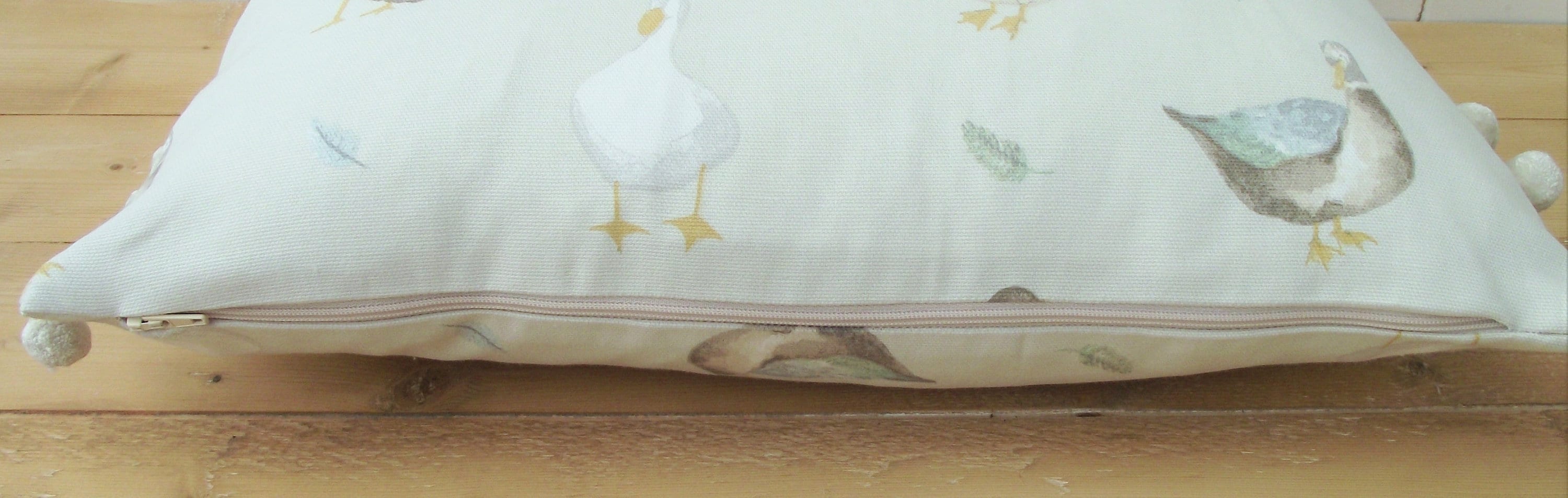 Jenny Duck Cushion with Pom Poms, Ducks Pattern on both side with a zip fastening.