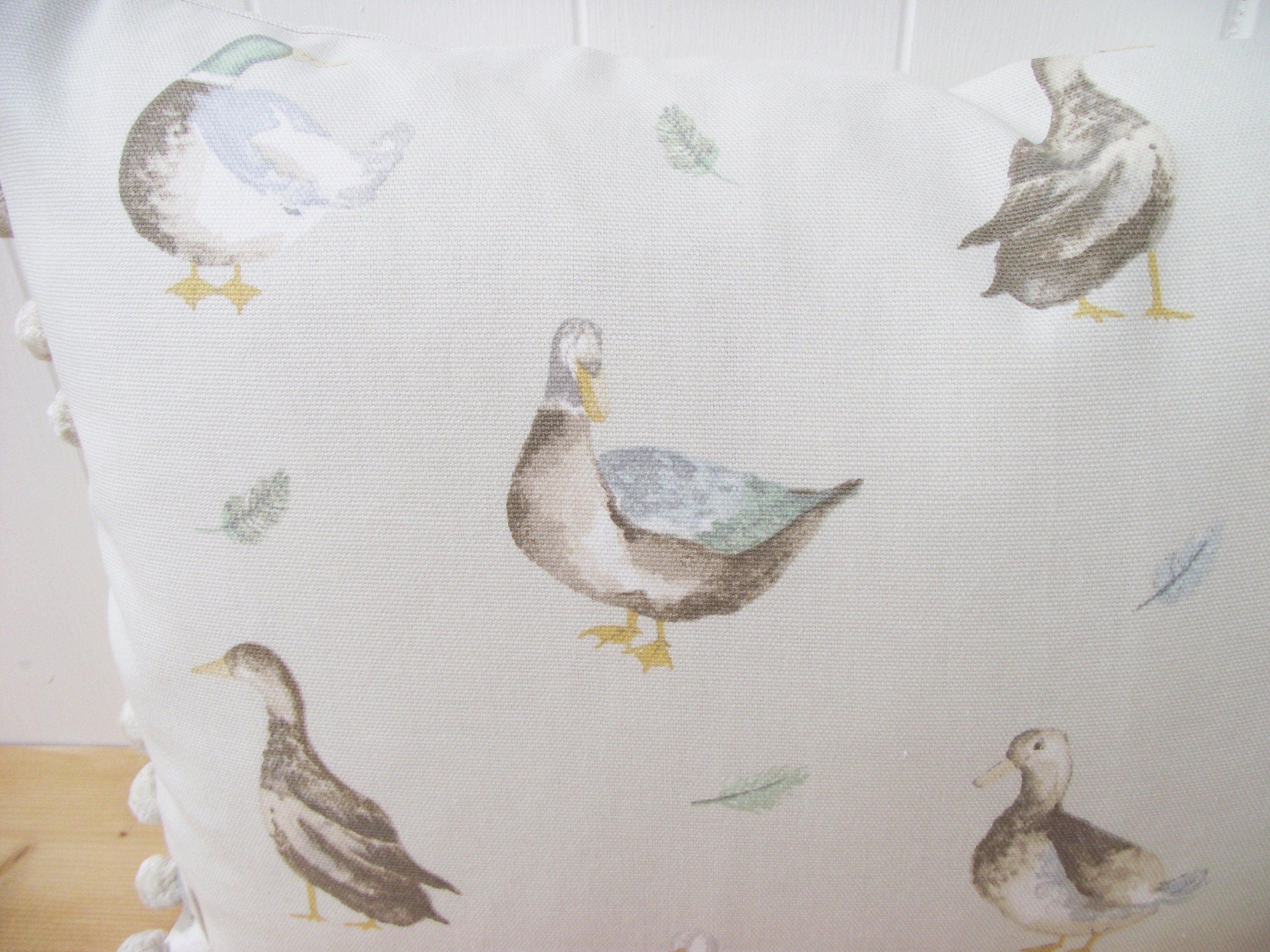 Jenny Duck Cushion with Pom Poms, Ducks Pattern on both side with a zip fastening.